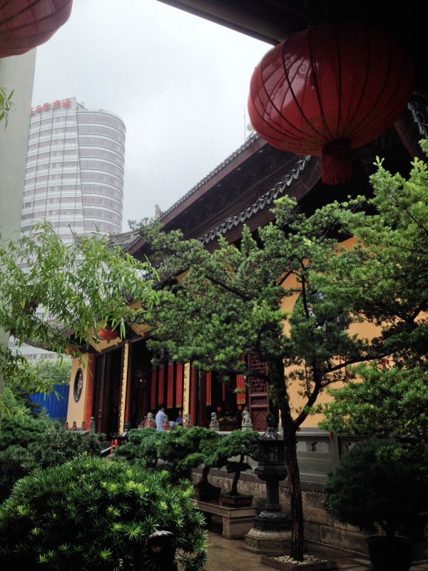Jade Buddha Temple juxtaposed with a nearby modern building.